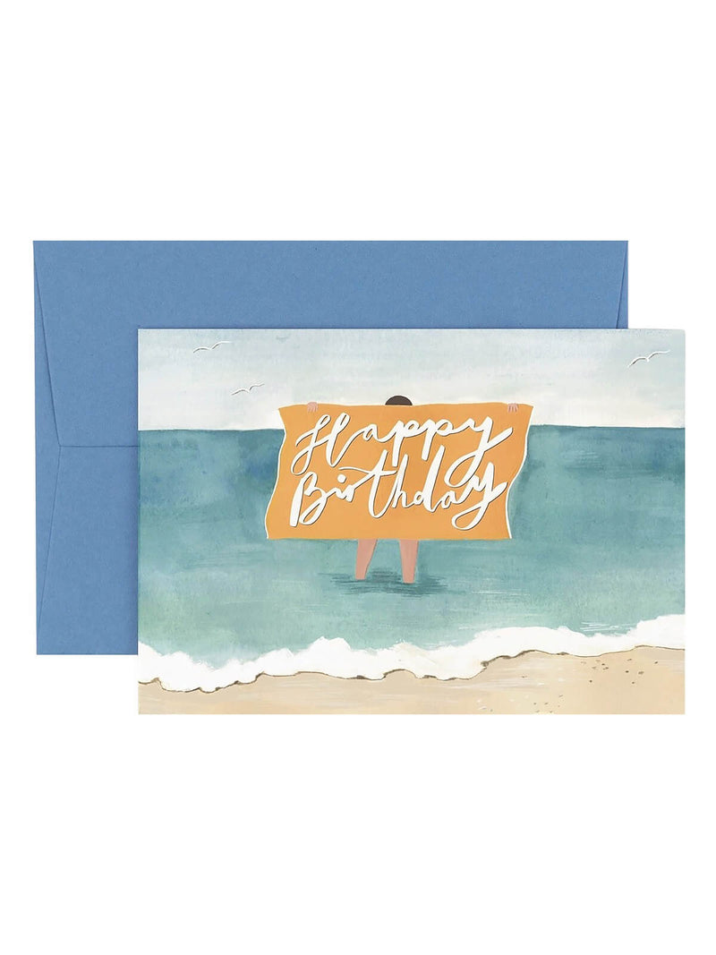 Birthday card with beach scene and 'Happy Birthday' text, featuring a blue envelope.
