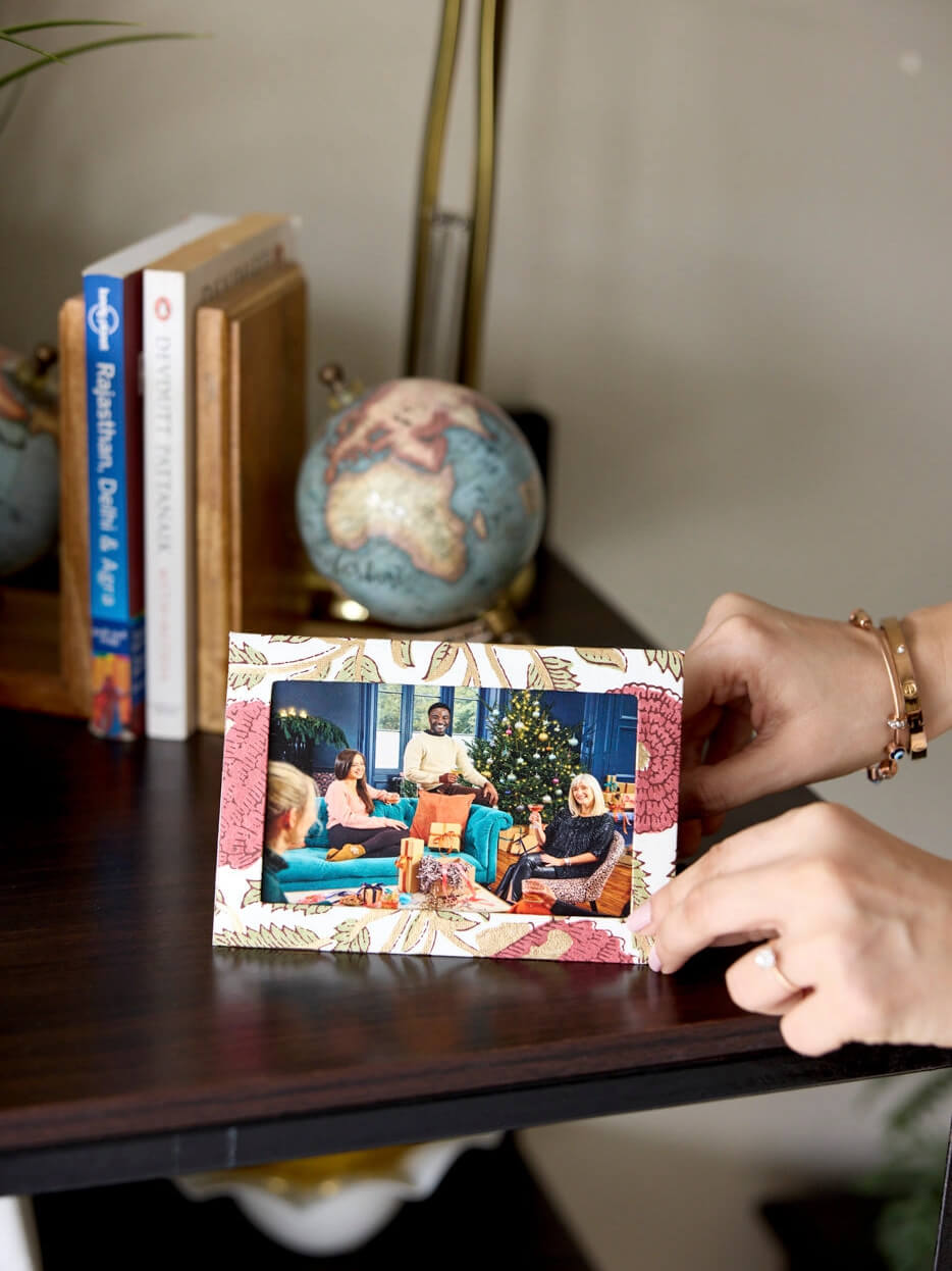 A decorative photo frame Christmas card with a family picture