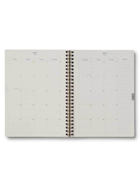 Spiral-bound planner with a grid layout on a white background