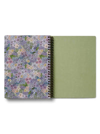 Notebook with floral cover and green back cover on a white background