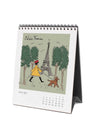 Calendar with illustration of  a woman walking a dog in front of the Eiffel Tower.