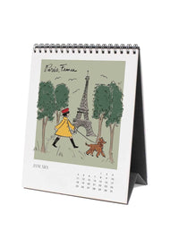 Calendar with illustration of  a woman walking a dog in front of the Eiffel Tower.