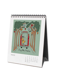Calendar with illustration of a woman in a dress standing in front of trees with ornaments in Taiwan.