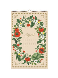 A spiral-bound August wall calendar featuring a vintage botanical illustration of tomatoes, lettuce, and white flowers in a wreath-like border on a cream background.