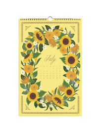 A July wall calendar featuring a yellow cover decorated with a wreath of sunflowers, green leaves, and small white flowers, with the word 'July' and a small calendar grid in the center.