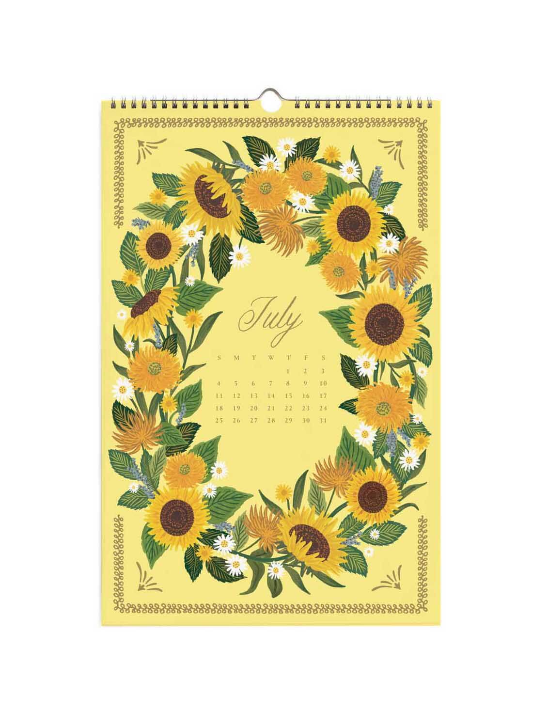 A July wall calendar featuring a yellow cover decorated with a wreath of sunflowers, green leaves, and small white flowers, with the word 'July' and a small calendar grid in the center.