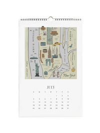 A spiral-bound July calendar page featuring a New York City map illustration with landmarks and a monthly calendar grid below.