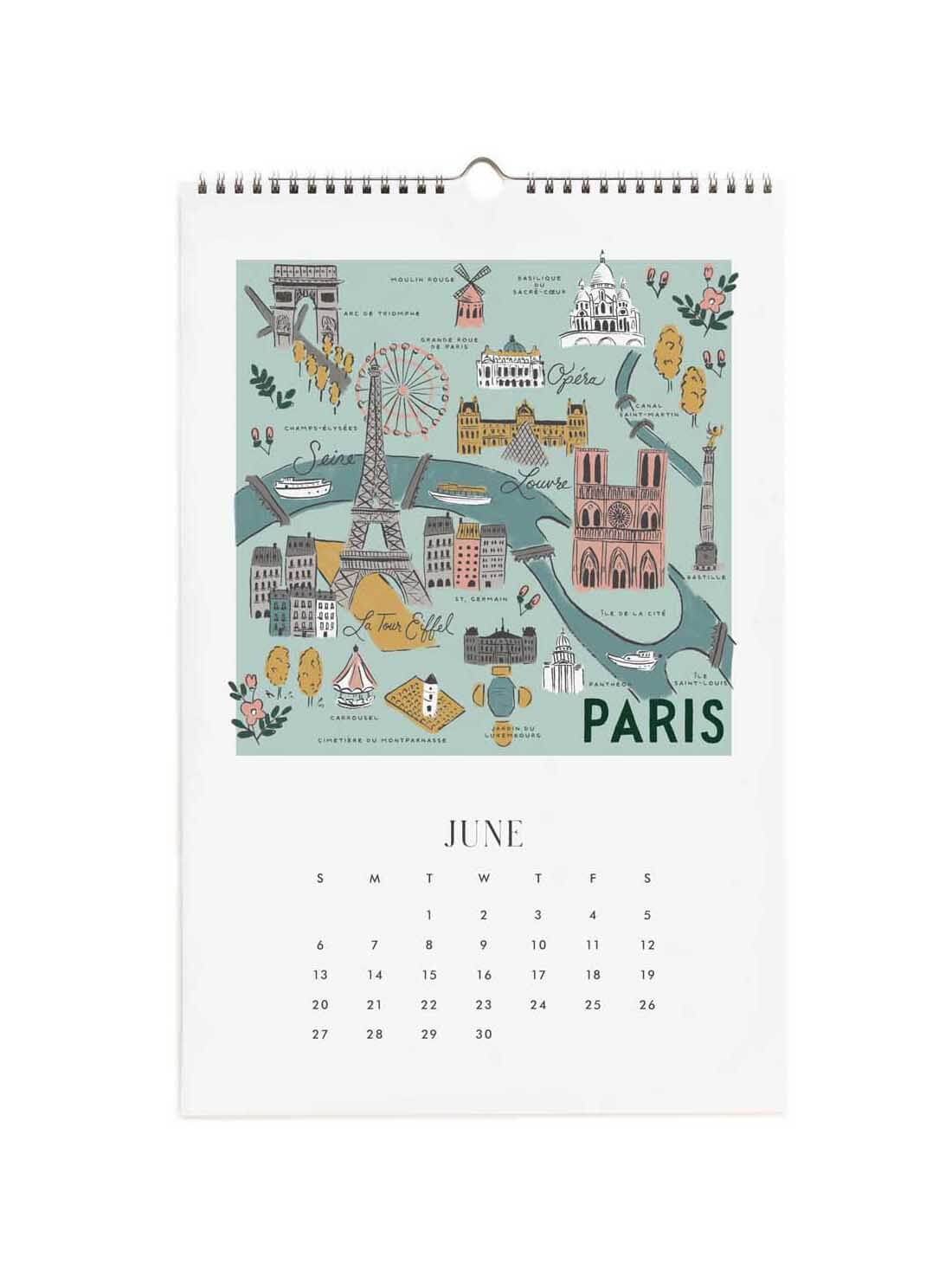 A spiral-bound Paris calendar page showing a colorful illustrated map of Paris landmarks on a mint background, with the word PARIS at the bottom and a June calendar grid below.