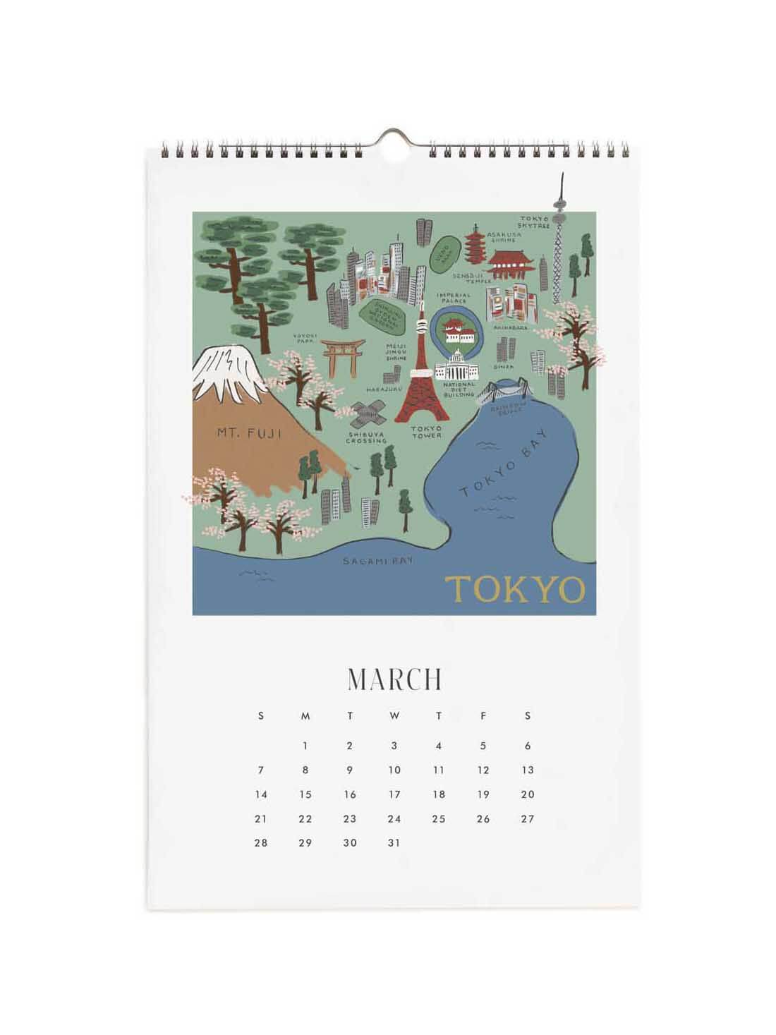 A spiral-bound hanging calendar page showing an illustrated map of Tokyo with Mount Fuji, the Tokyo Bay, and the word TOKYO, plus the March calendar dates below on a white page.