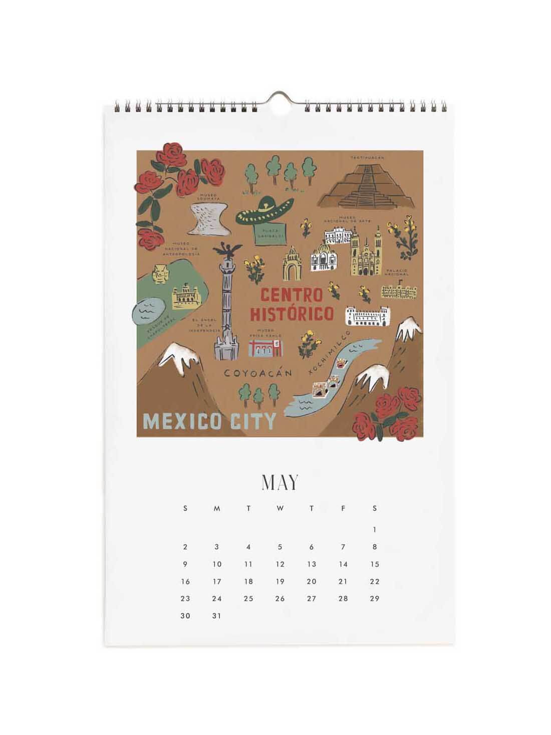 A spiral-bound wall calendar page for Mexico City, May, featuring a brown illustrated map labeled 'Centro Histórico' with red roses, mountains, and other cultural landmarks above a May calendar grid.