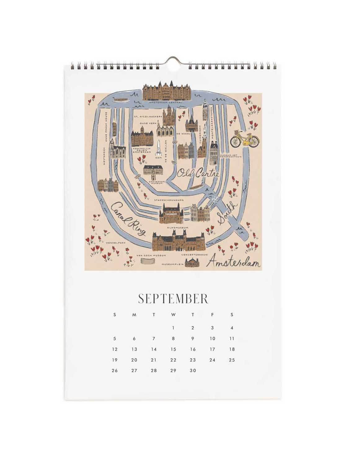 A spiral-bound September desk calendar featuring a vintage-style illustrated map of Amsterdam on the cover page, with a printed monthly calendar grid below.