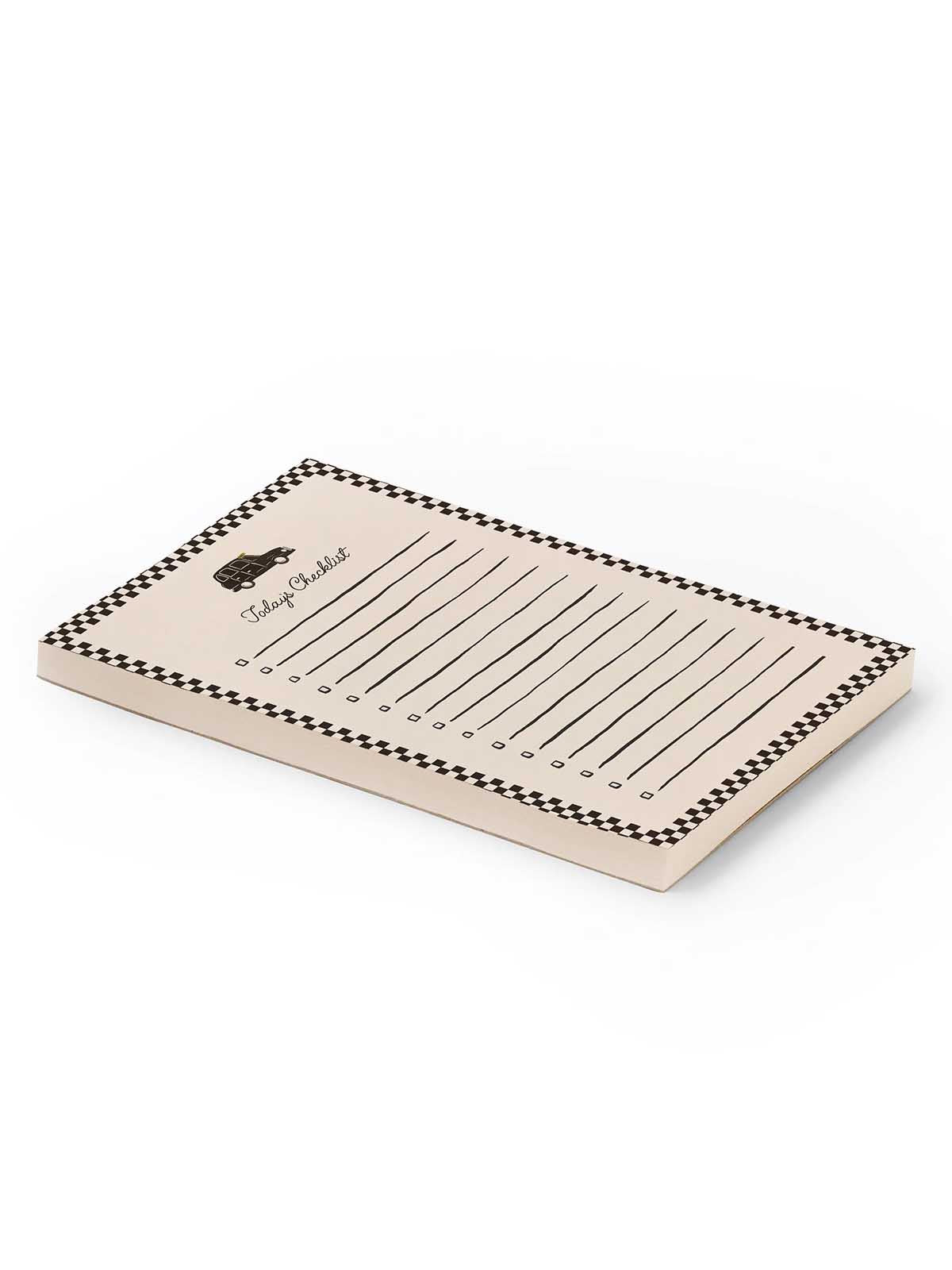 A beige notepad with a black and white checkered border, lined writing area, and a small black logo on the top left, shown on a clean white background.