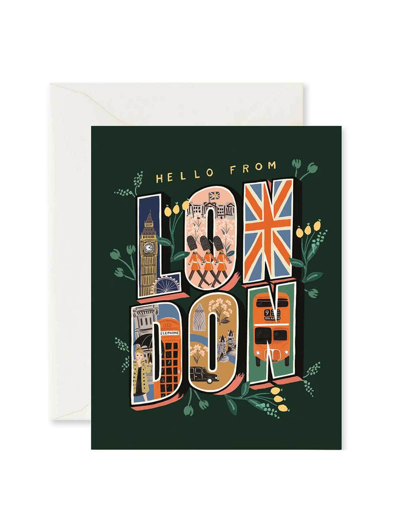 A London-themed greeting card with a dark green background and an illustrated collage of city landmarks, red buses, and the Union Jack inside the word 'LONDON'. A white envelope is partially visible behind the card.