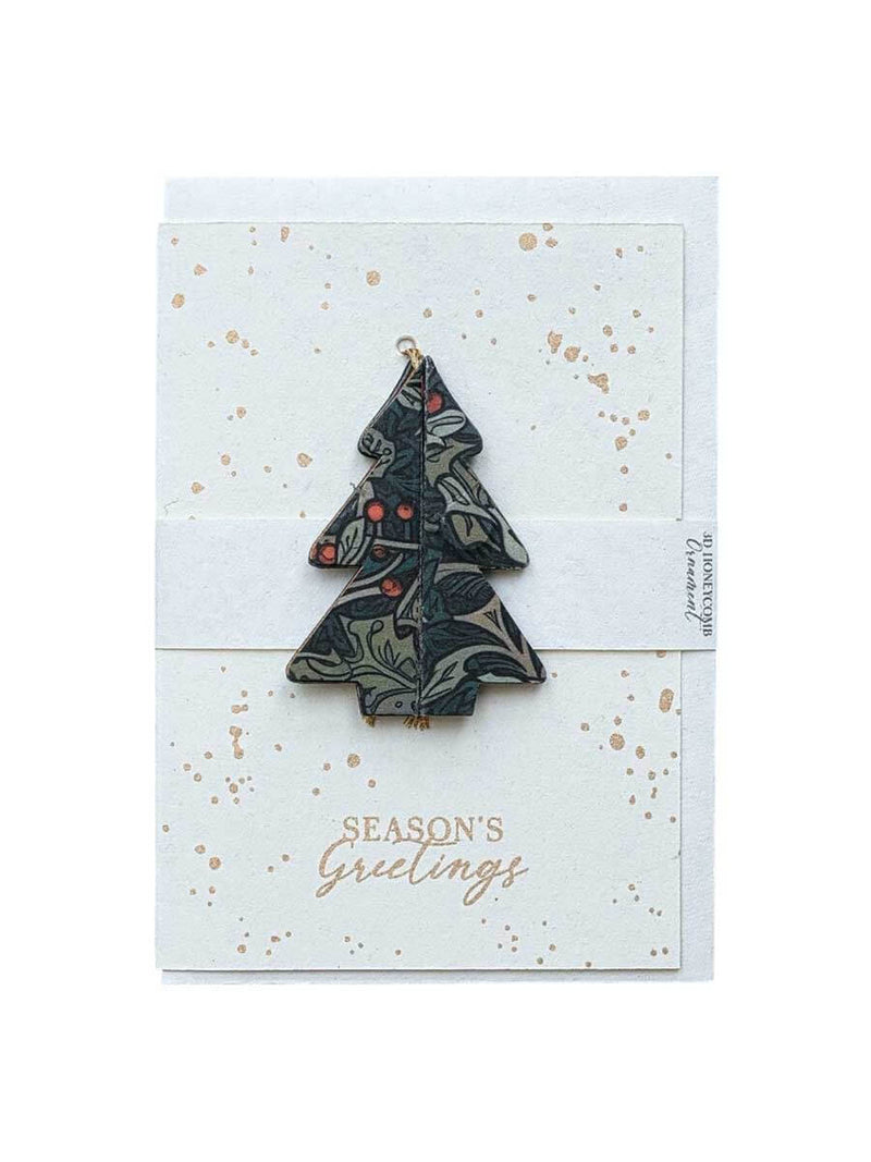Christmas tree-shaped ornament on a 'Season's Greetings' card with gold accents.
