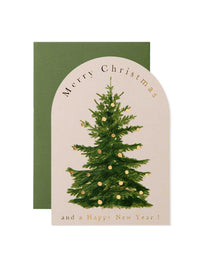 A Christmas greeting card with an arched cream front featuring a green Christmas tree with gold ornaments and the text 'Merry Christmas and a Happy New Year!', shown with a dark green envelope behind it on a white background.