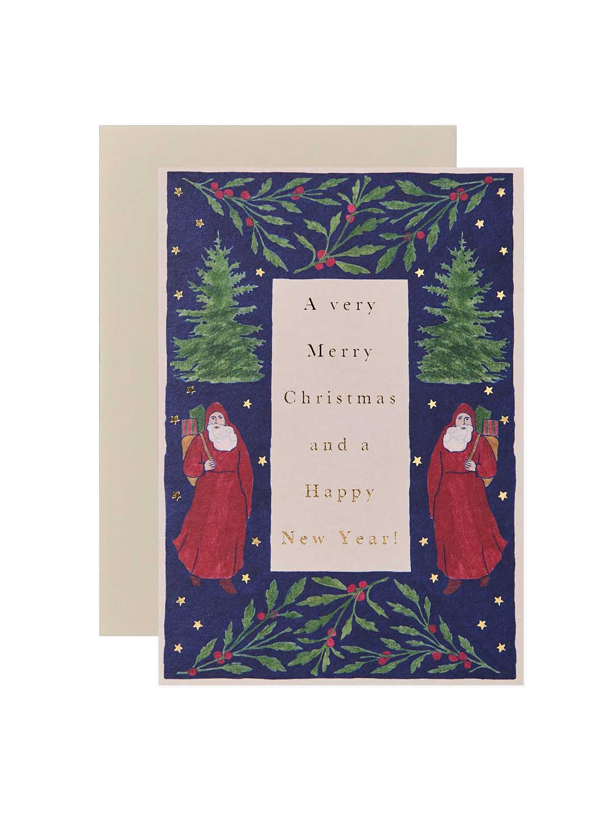 A Christmas greeting card with a navy blue background, green holly and pine tree illustrations, and two Santa Claus figures, shown with a beige envelope behind it on a white background.